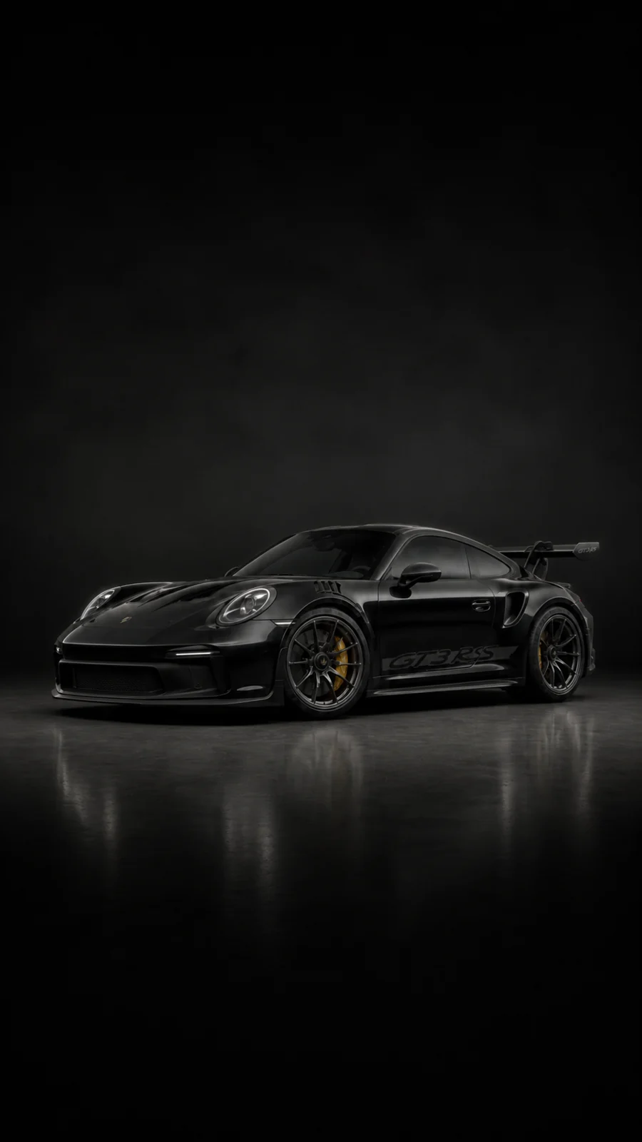 Black Porsche 911 GT3 RS inside a dark detailing studio