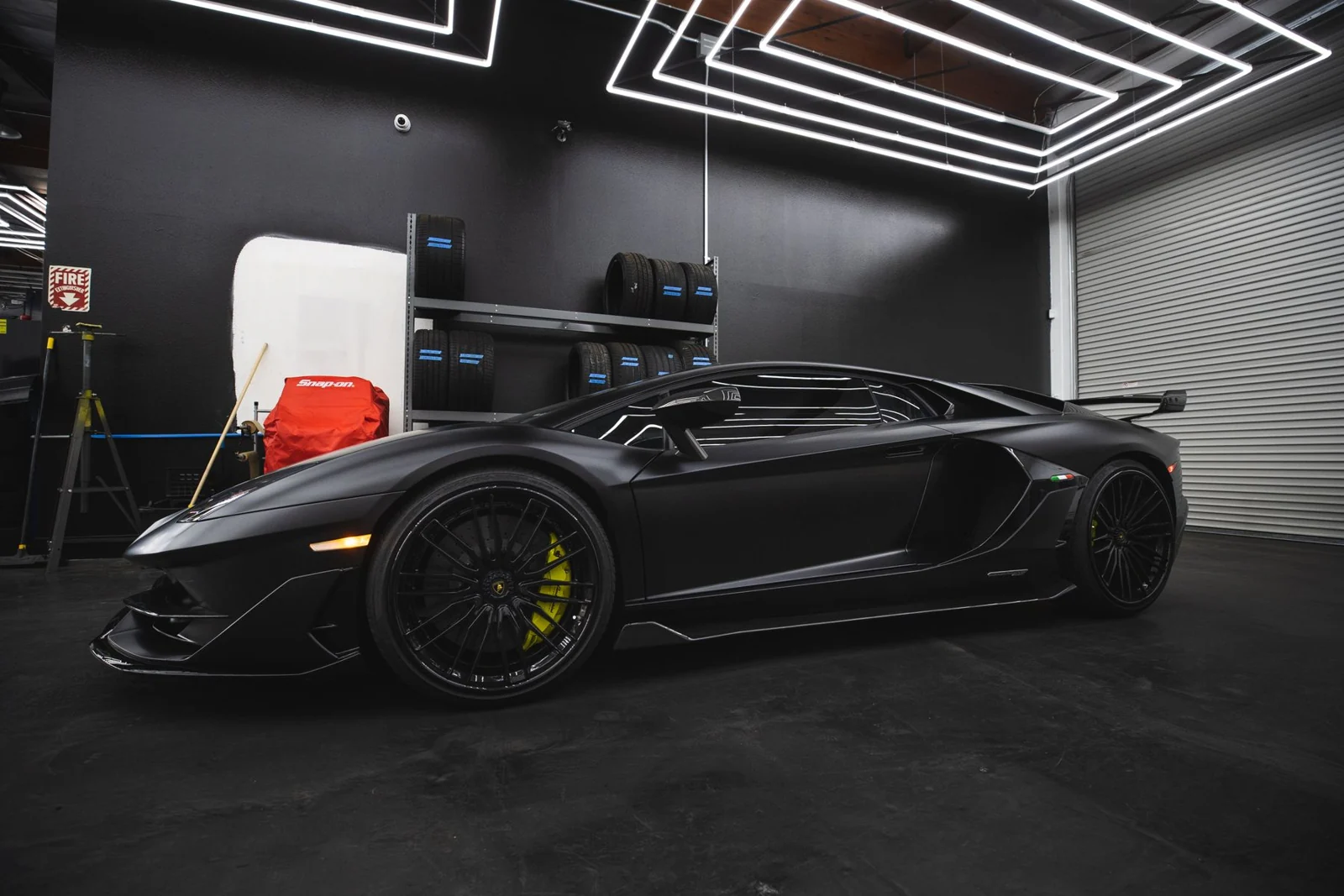 Black sports car in a detailing studio