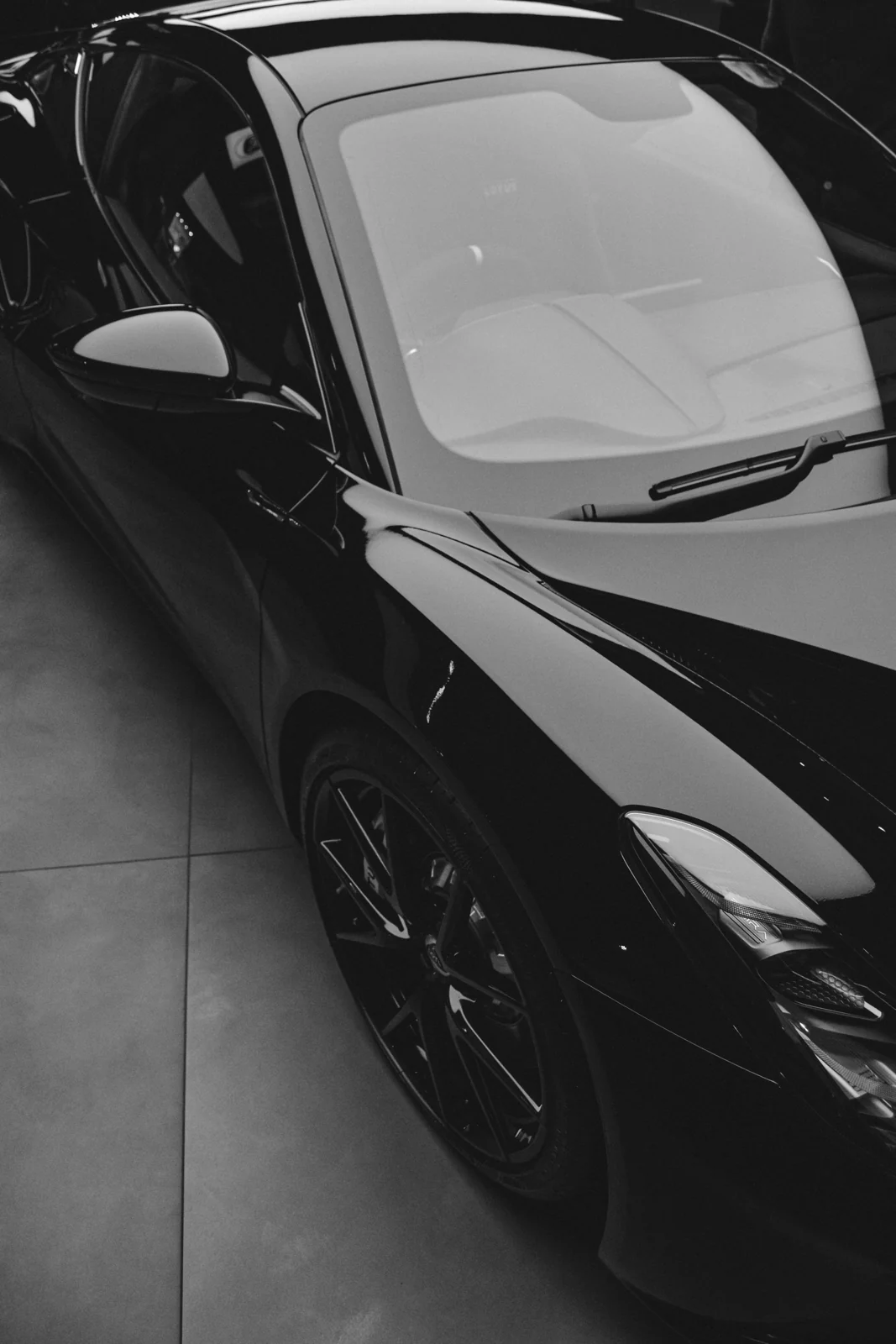 Black sports car in a modern garage